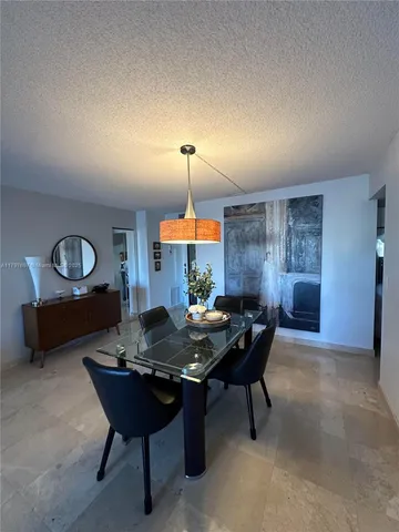 a living room with furniture and kitchen