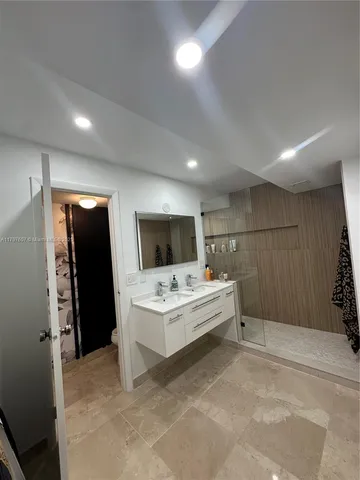 a bedroom with a large bed and a balcony view