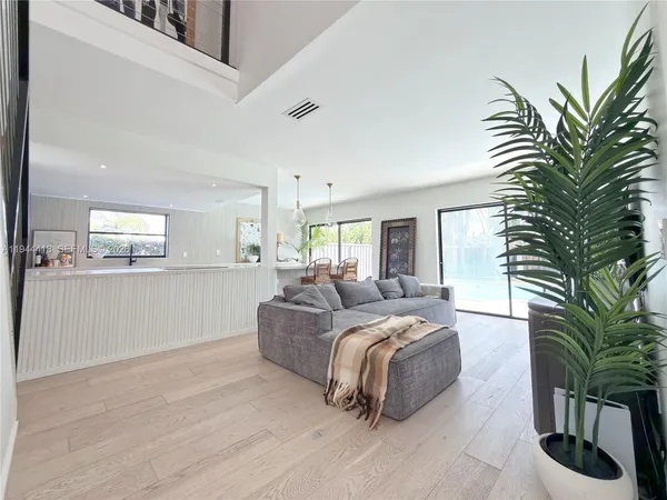 a bedroom with a large bed and a potted plant