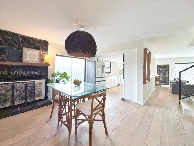 a dining room with furniture and wooden floor