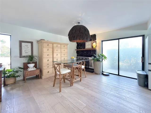 a dining room with furniture window and wooden floor