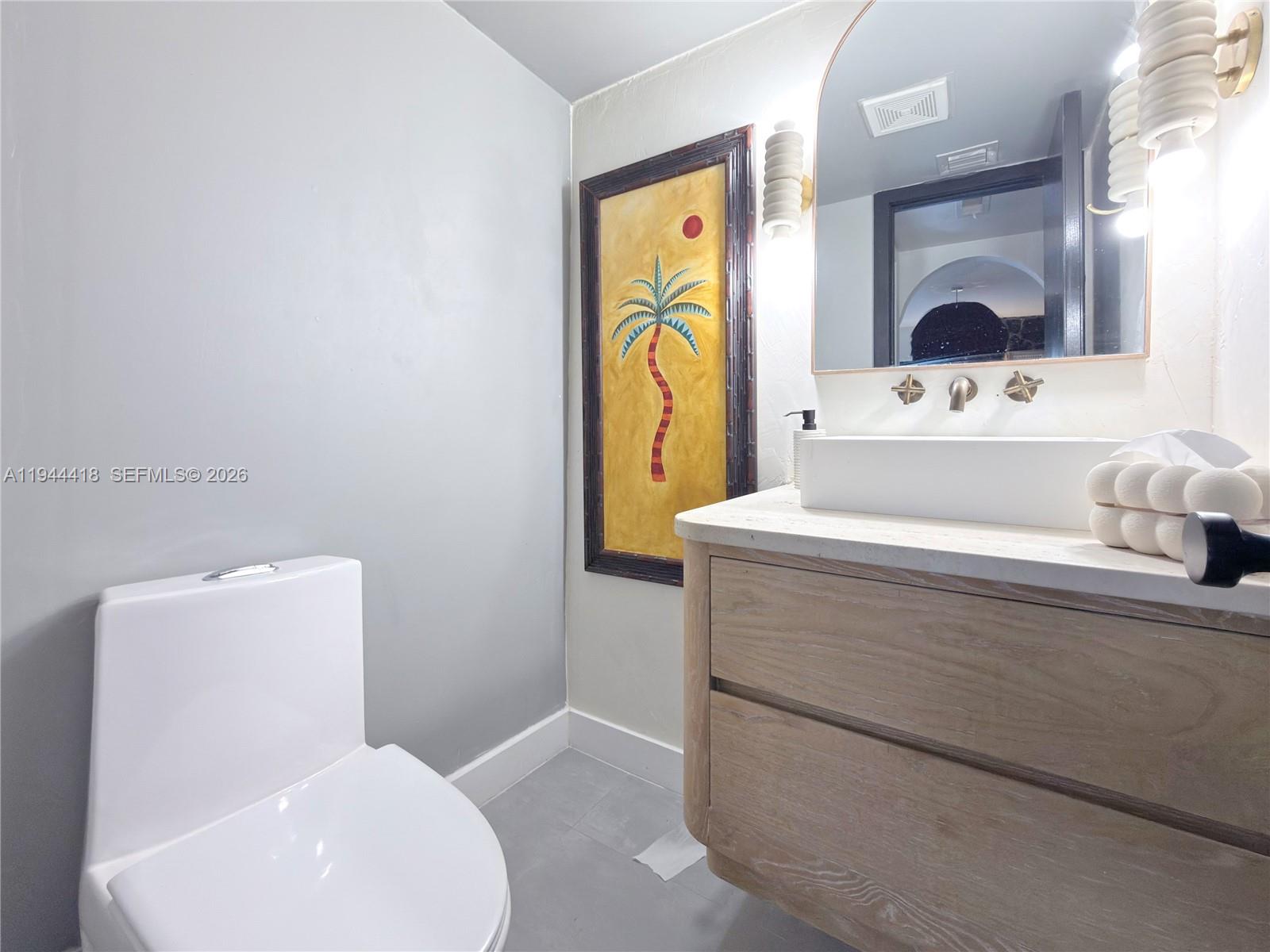 760 Windtree Way Wellington, FL 33414 - Photo 21 of 45 a bathroom with a toilet sink and mirror