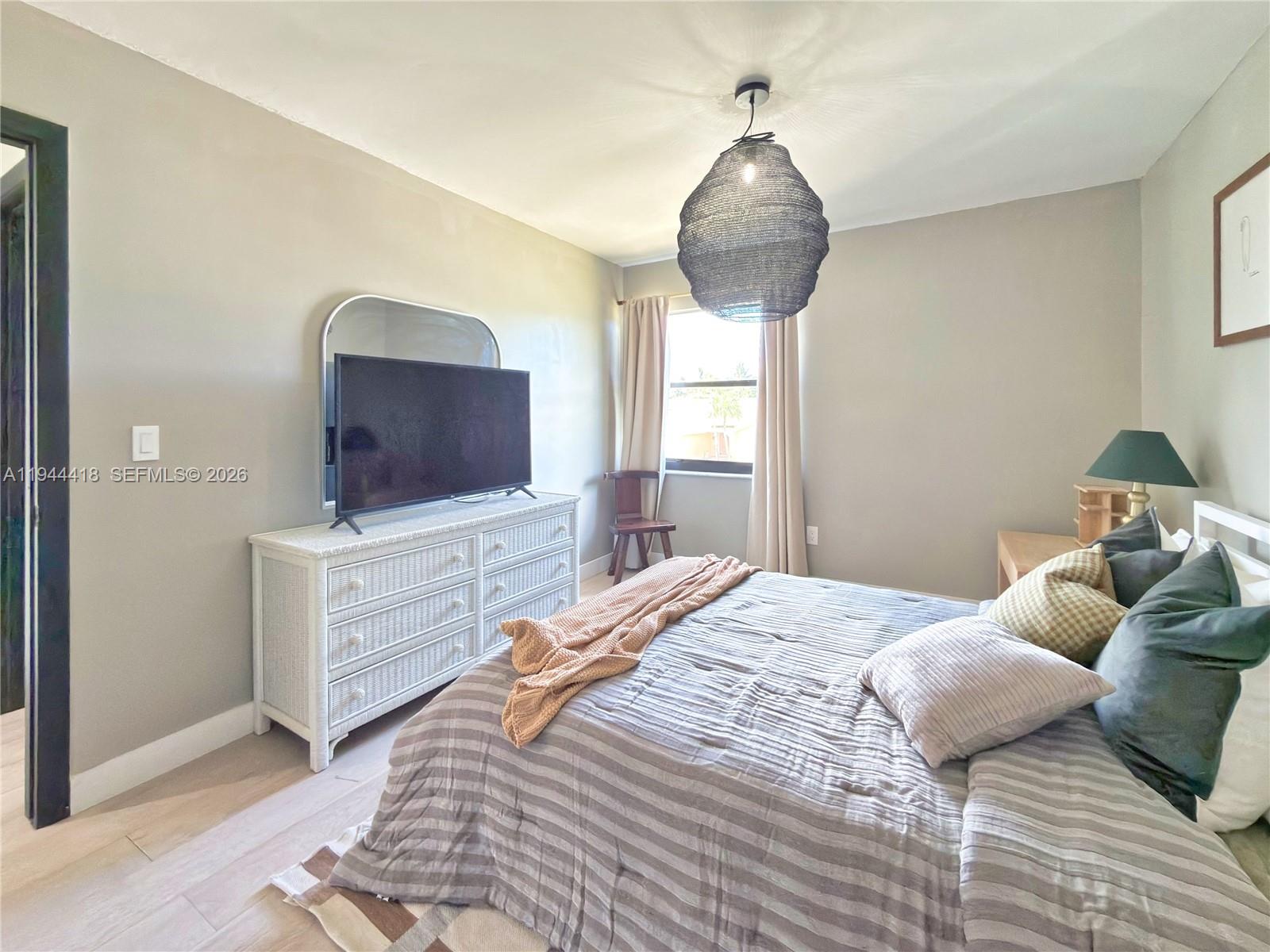 760 Windtree Way Wellington, FL 33414 - Photo 24 of 45 a bedroom with a bed and a flat screen tv