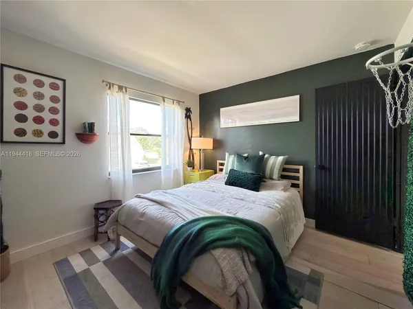 a bedroom with a bed and a window