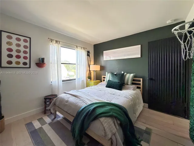 a bedroom with a bed and a window