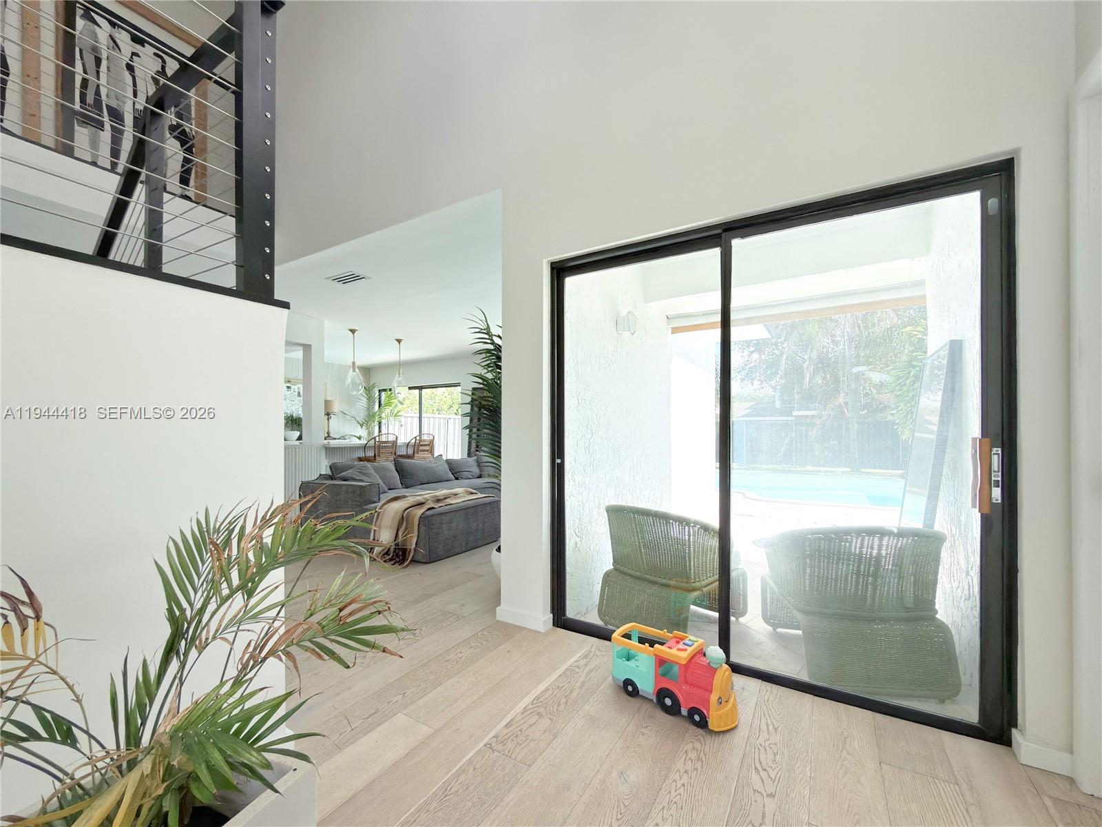 760 Windtree Way Wellington, FL 33414 - Photo 3 of 45 a room with furniture and a large window