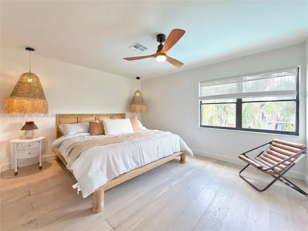 a bedroom with furniture and a rug