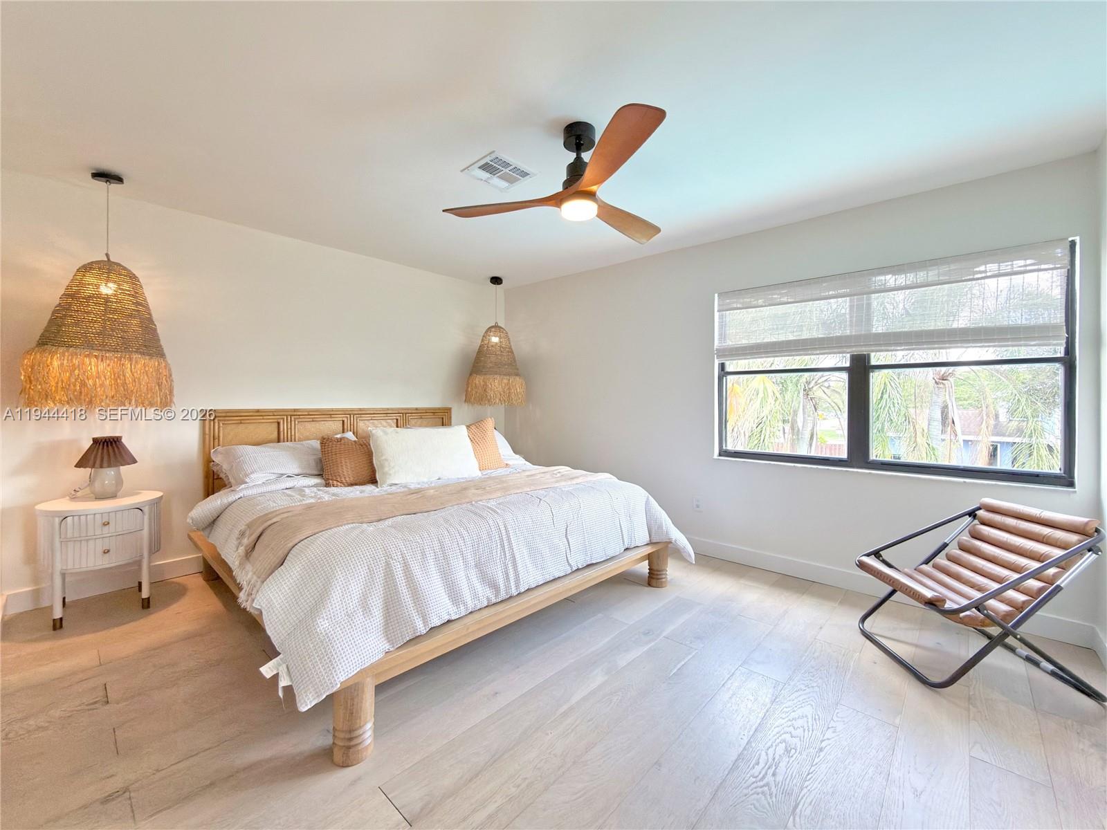 760 Windtree Way Wellington, FL 33414 - Photo 31 of 45 a bedroom with bed and window