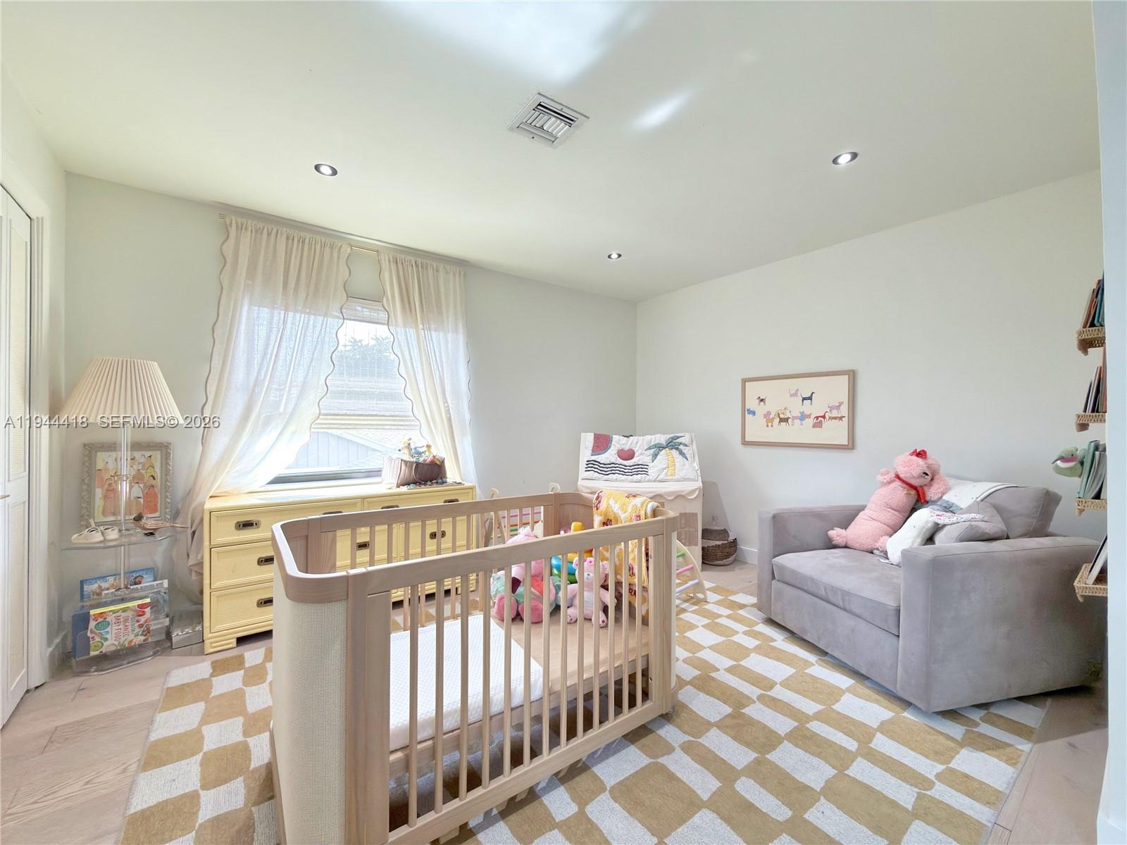 760 Windtree Way Wellington, FL 33414 - Photo 36 of 45 a bedroom with furniture a baby crib and a window