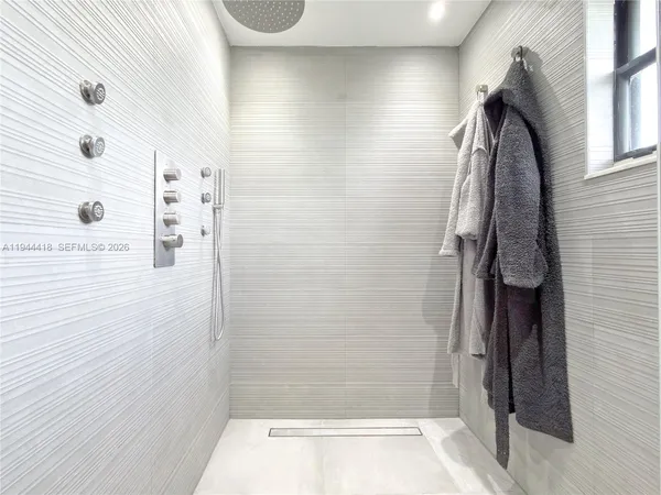 a bathroom with a toilet sink vanity tub and mirror