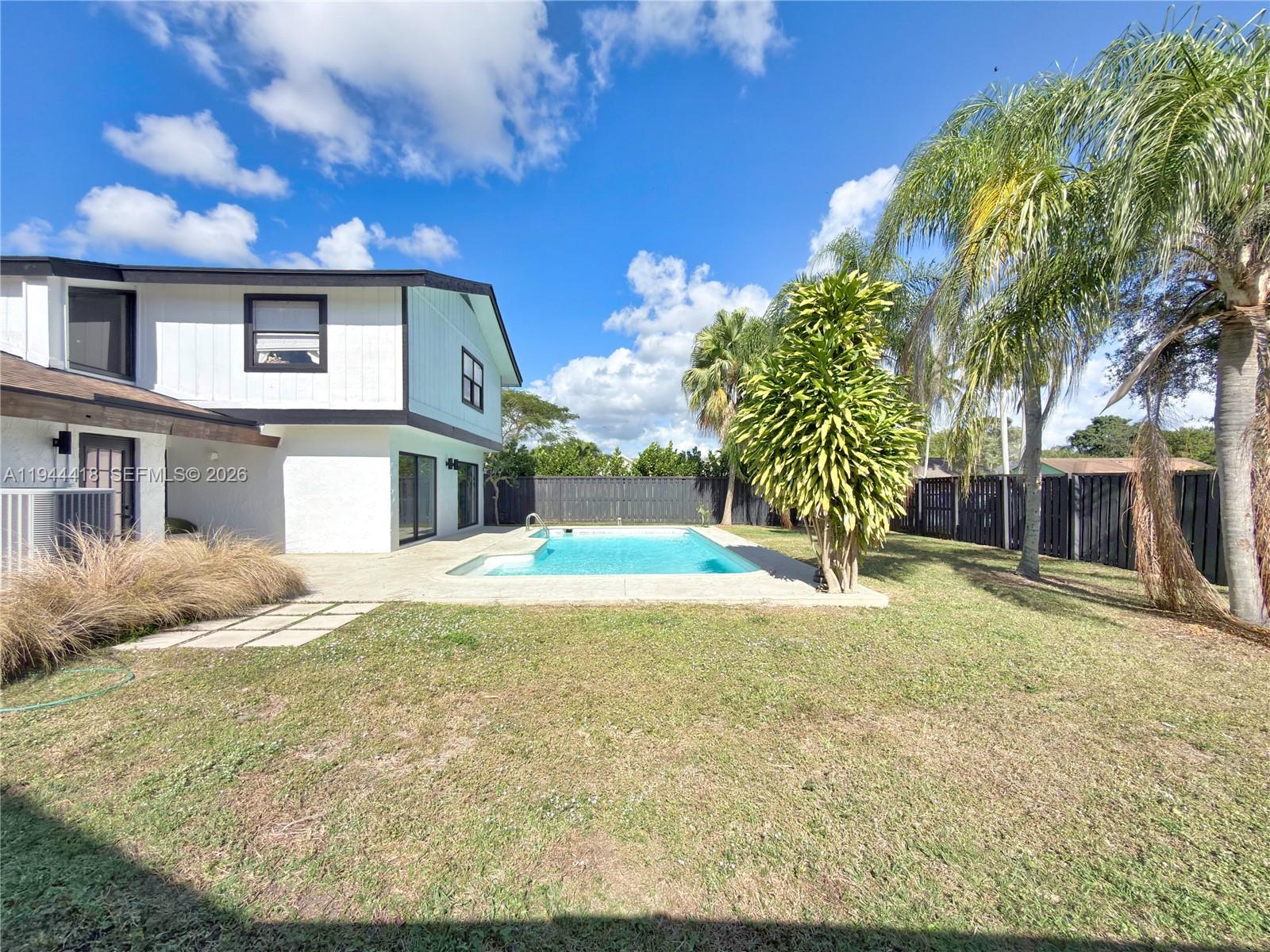 760 Windtree Way Wellington, FL 33414 - Photo 42 of 45 a house view with a backyard space