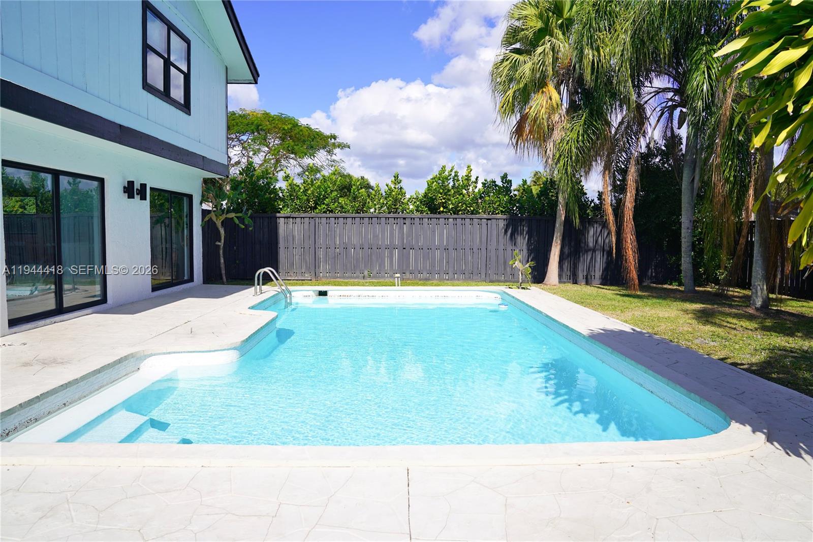 760 Windtree Way Wellington, FL 33414 - Photo 44 of 45 a swimming pool with an outdoor space
