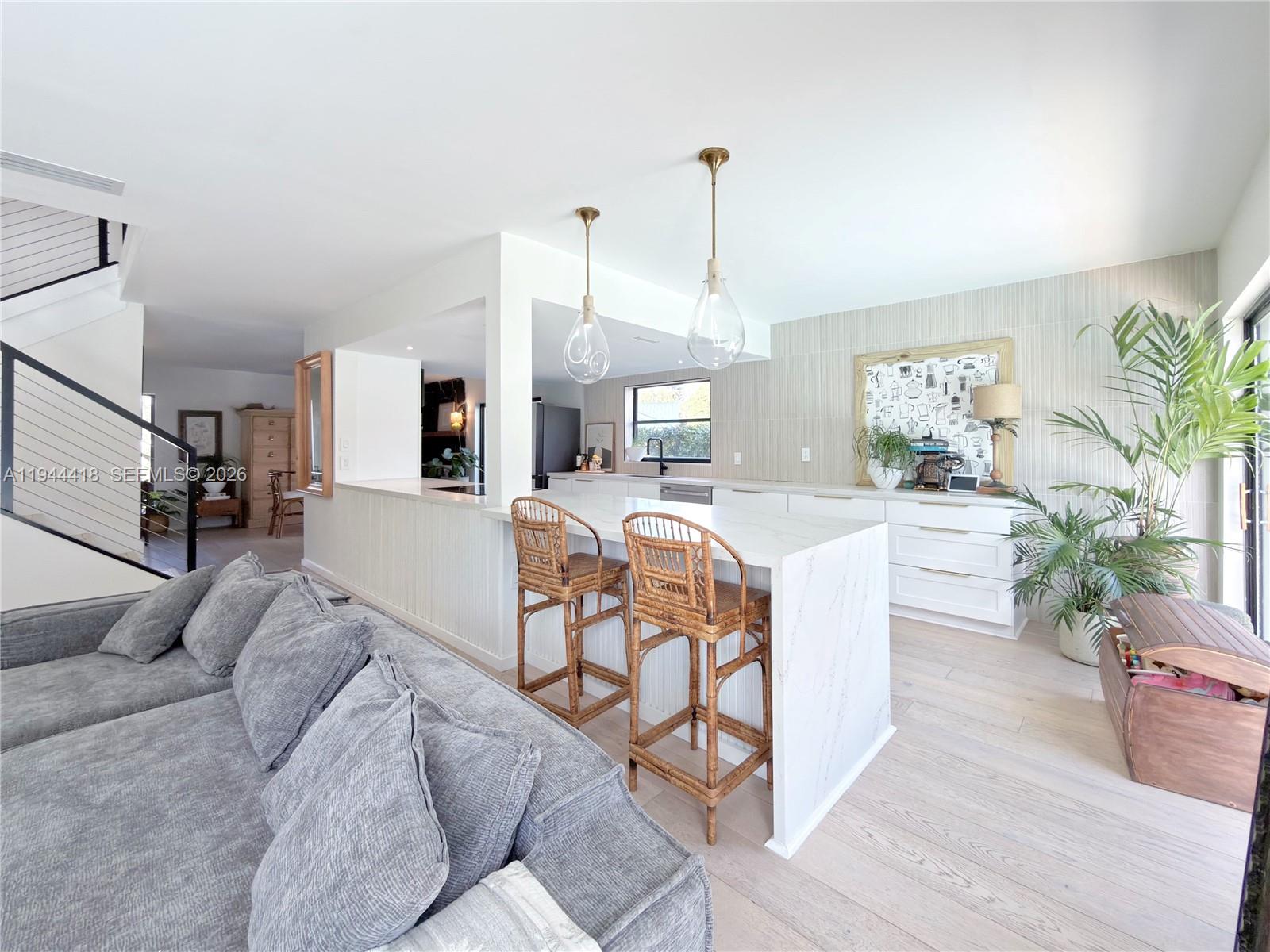 760 Windtree Way Wellington, FL 33414 - Photo 9 of 45 a living room with furniture kitchen view and a chandelier