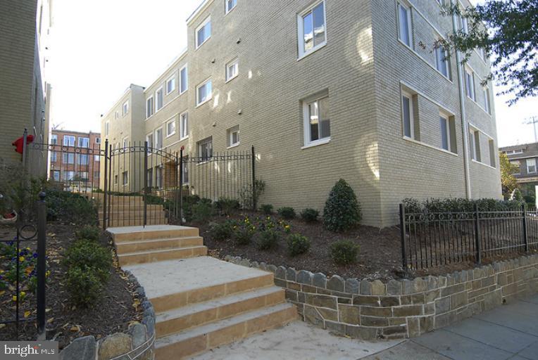 1901 Lincoln Road Northeast, Unit 303 Washington, DC 20002 - Photo 2 of 15 a view of a brick building with many windows