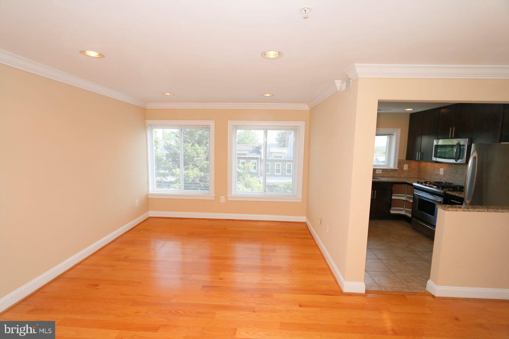 1901 Lincoln Road Northeast, Unit 303 Washington, DC 20002 - Photo 5 of 15 a view of a kitchen with a sink dishwasher and a fireplace
