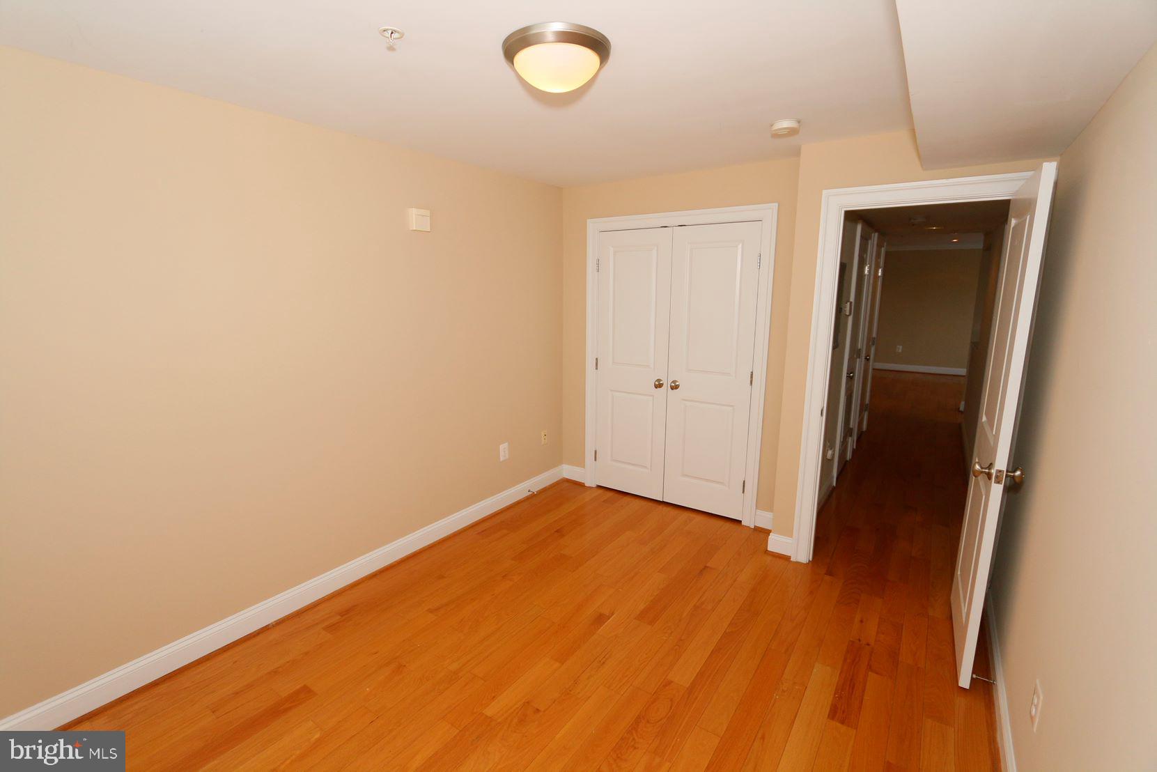 1901 Lincoln Road Northeast, Unit 303 Washington, DC 20002 - Photo 10 of 15 a view of an empty room with wooden floor