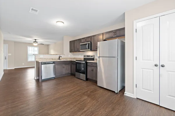 a kitchen with stainless steel appliances a refrigerator and a stove top oven