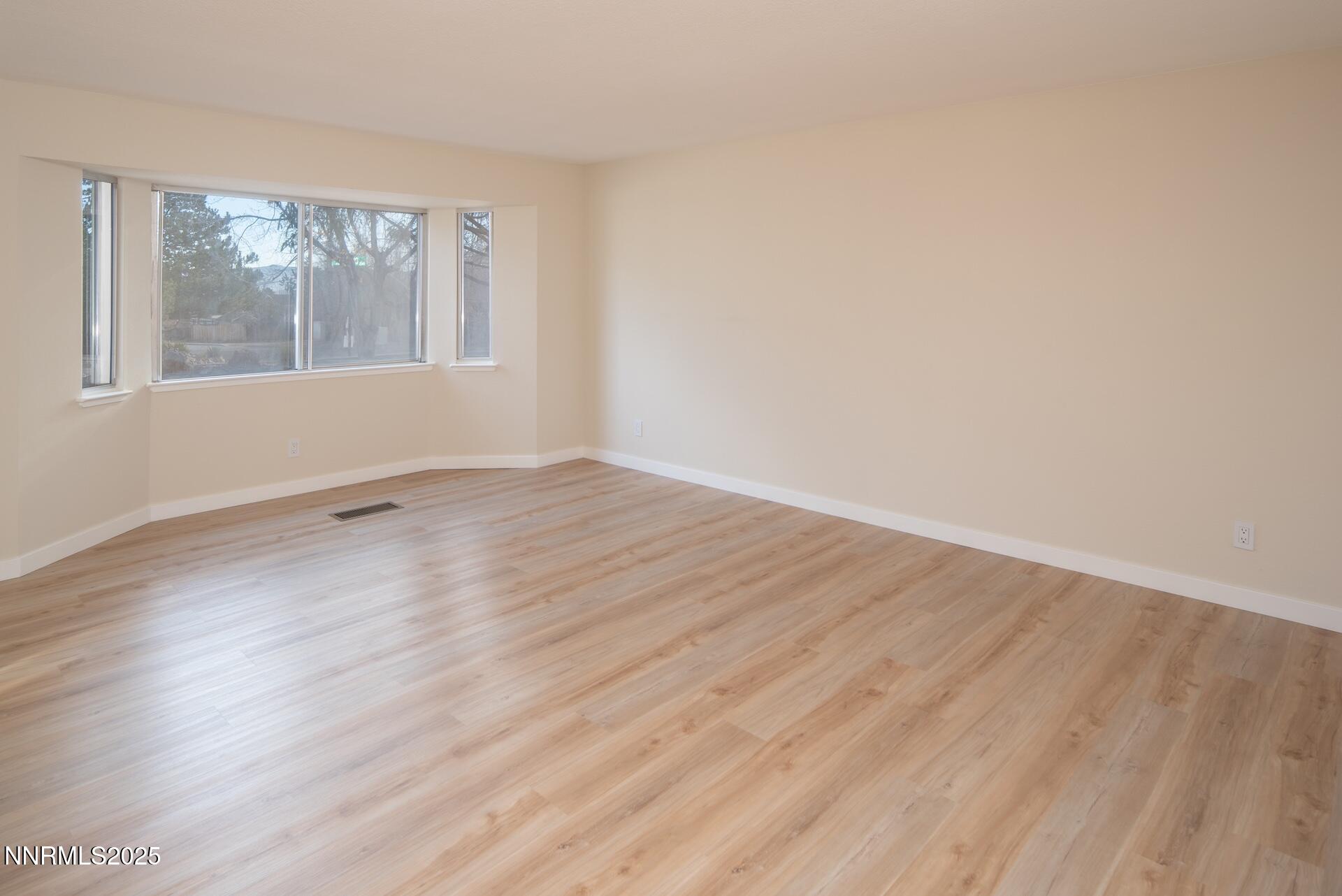 1605 Alamo Street Reno, NV 89503 - Photo 15 of 44 an empty room with wooden floor and windows