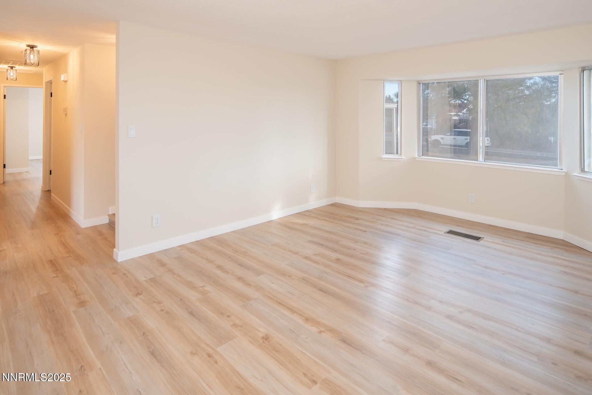 1605 Alamo Street Reno, NV 89503 - Photo 17 of 44 a view of an empty room with wooden floor and a window