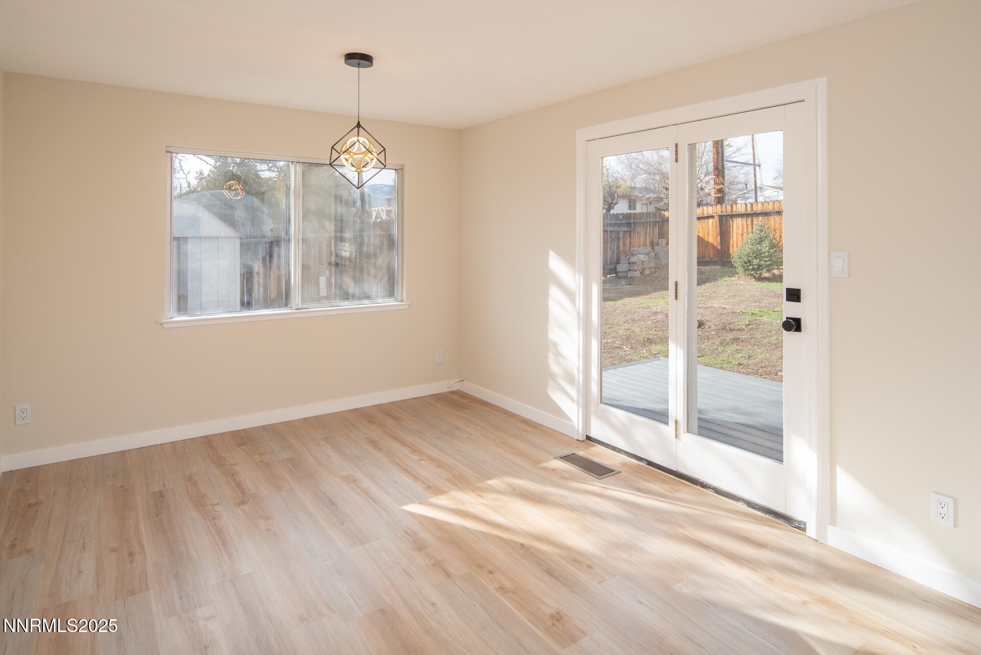 1605 Alamo Street Reno, NV 89503 - Photo 20 of 44 a view of an empty room with wooden floor and a window