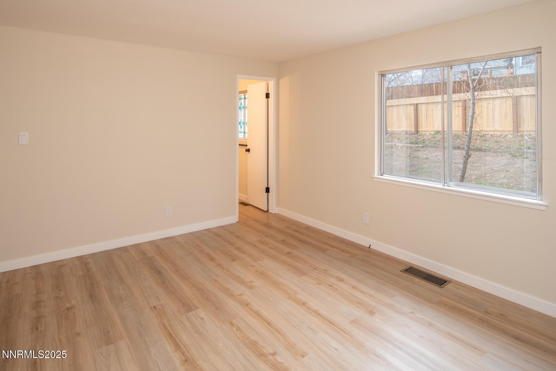 1605 Alamo Street Reno, NV 89503 - Photo 26 of 44 an empty room with wooden floor and windows