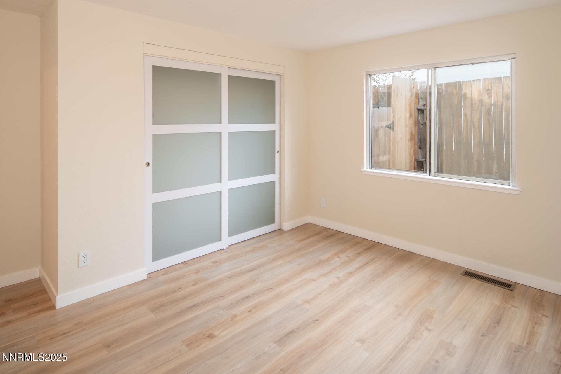 1605 Alamo Street Reno, NV 89503 - Photo 31 of 44 an empty room with wooden floor and windows