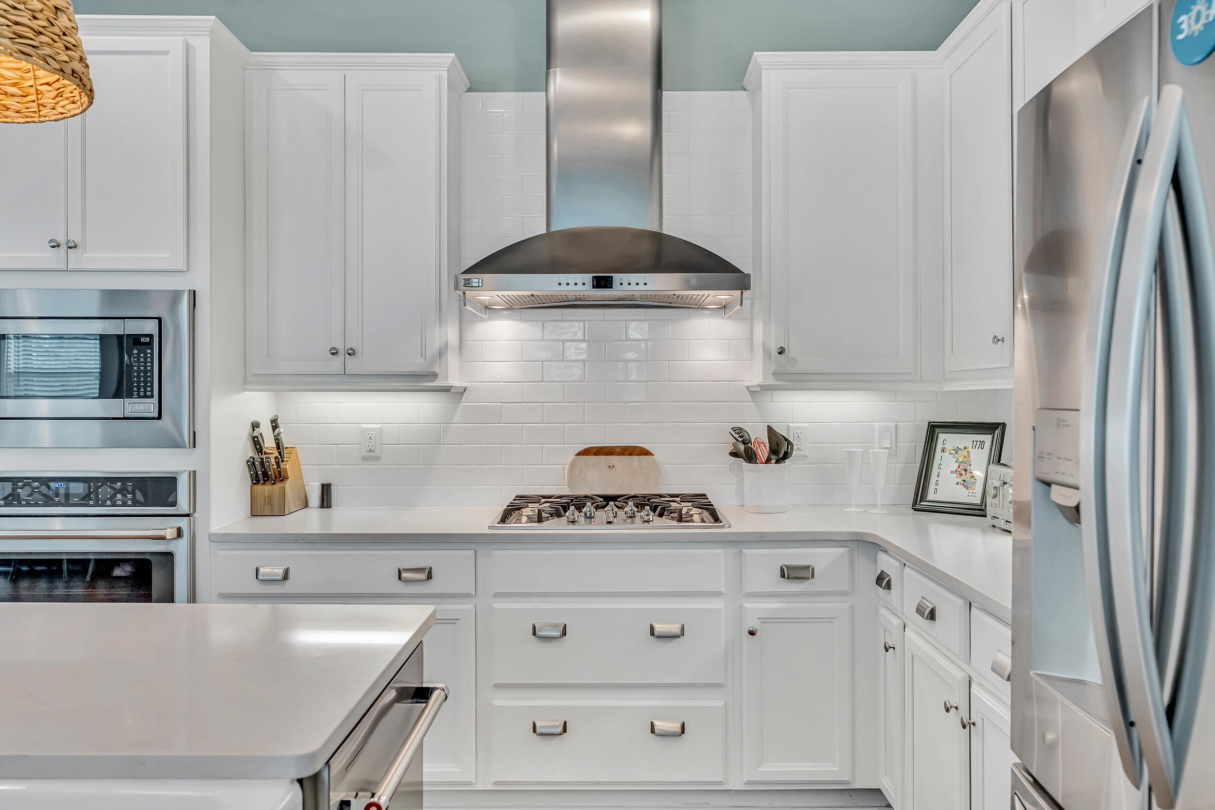 654 Flatwoods Forest Loop Santa Rosa Beach, FL 32459 - Photo 11 of 53 a kitchen with stainless steel appliances a refrigerator a stove and white cabinets