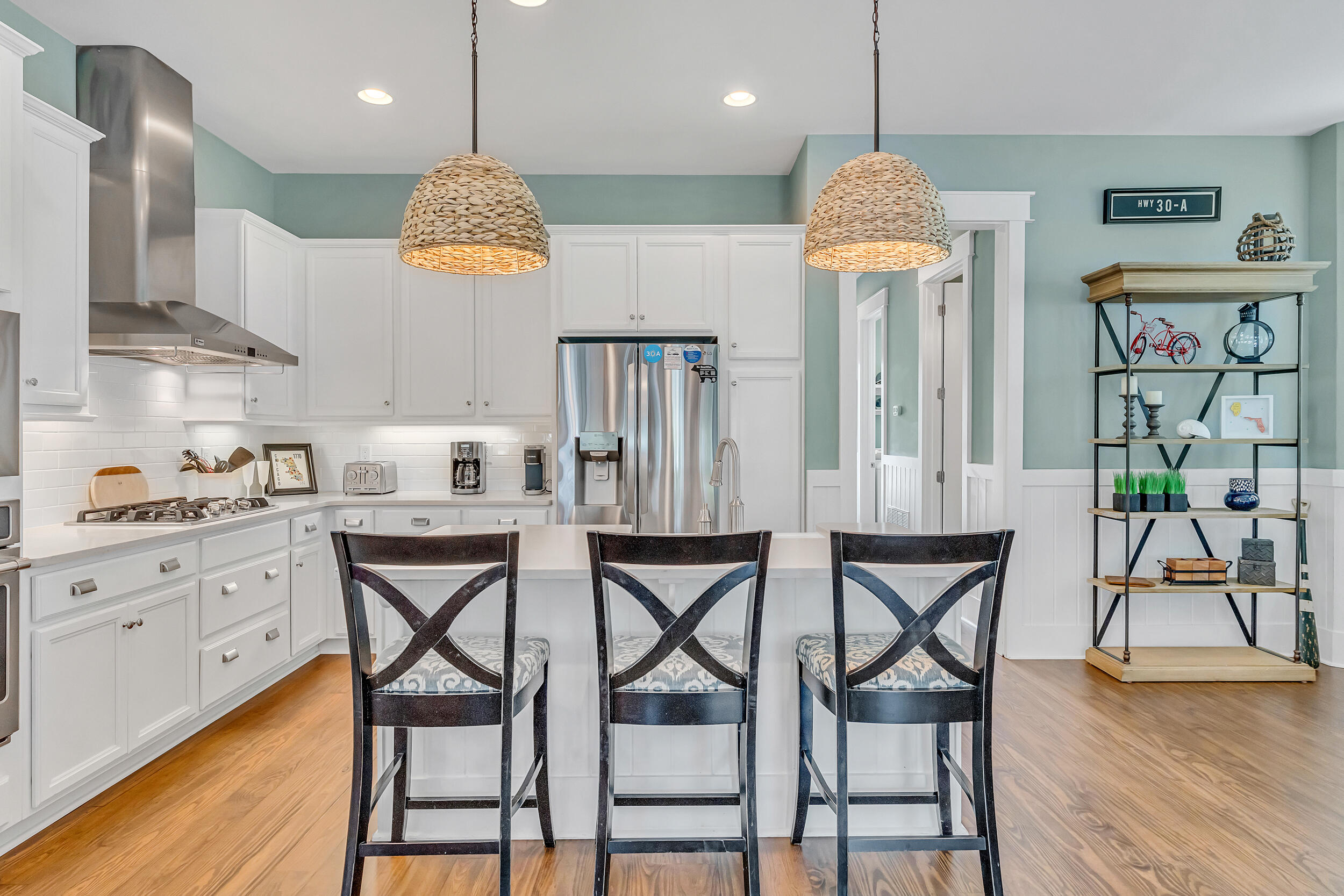 654 Flatwoods Forest Loop Santa Rosa Beach, FL 32459 - Photo 13 of 53 a kitchen with stainless steel appliances granite countertop table chairs sink and stove top oven
