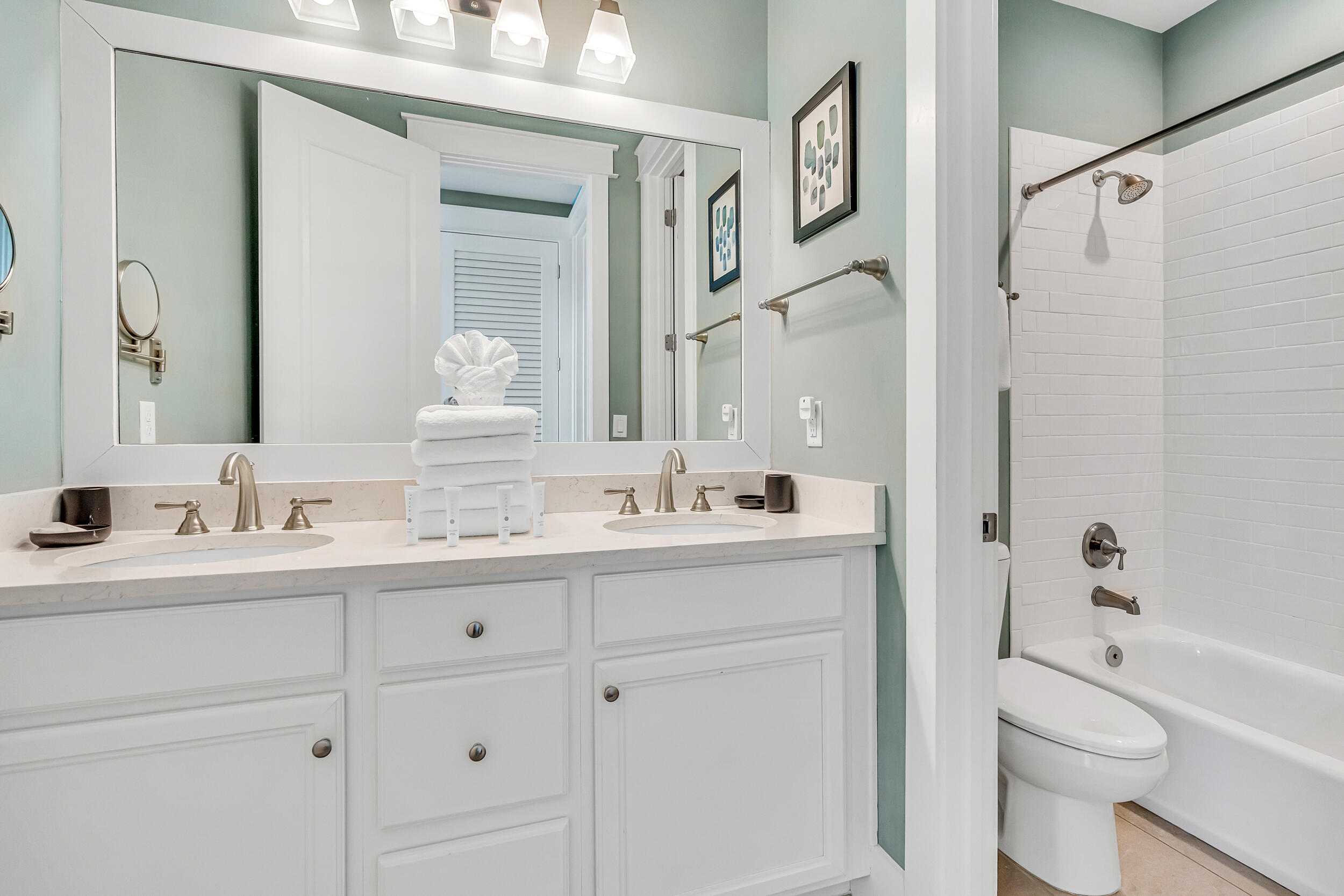 654 Flatwoods Forest Loop Santa Rosa Beach, FL 32459 - Photo 28 of 53 a bathroom with a granite countertop sink toilet a large mirror a bathtub and shower
