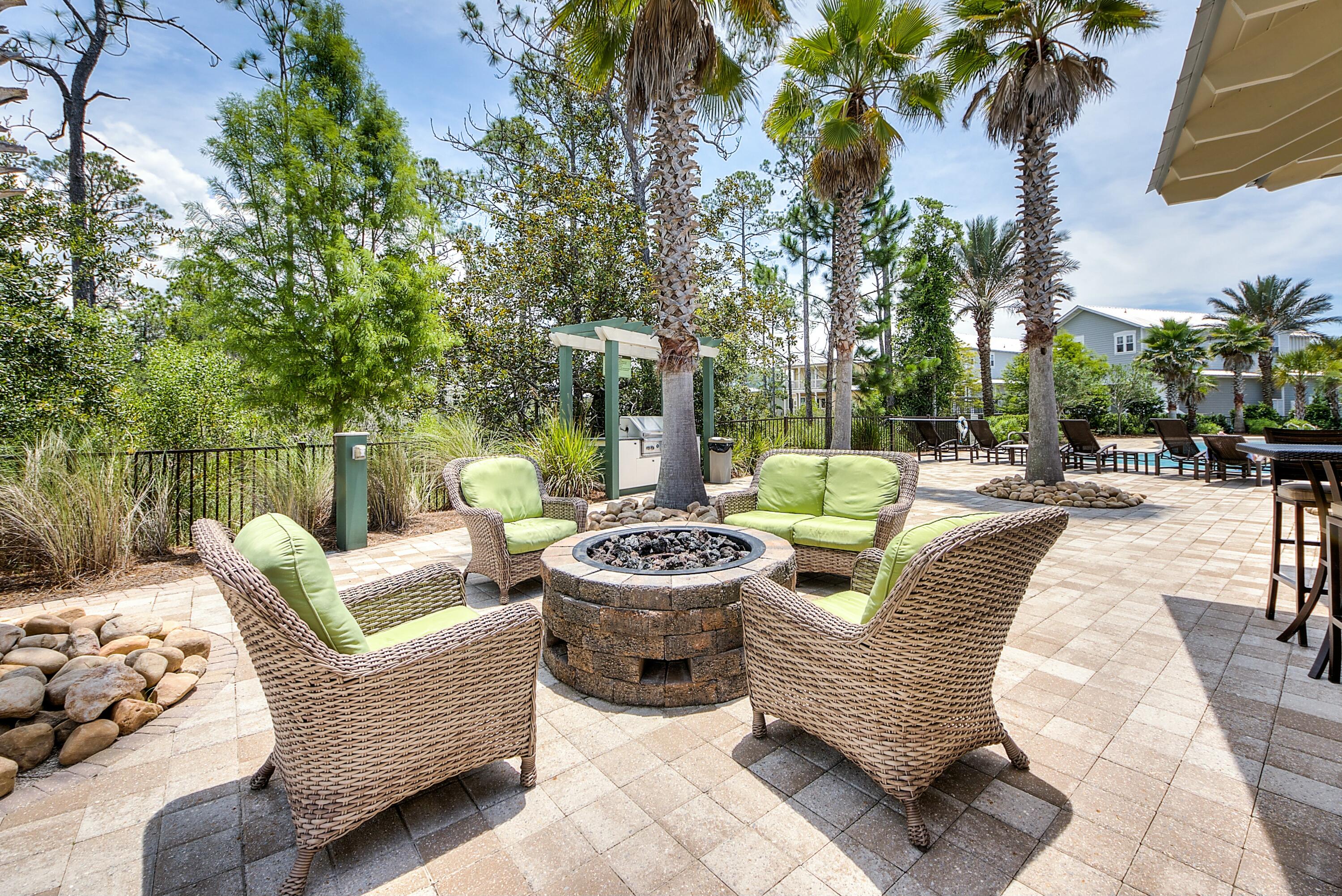 654 Flatwoods Forest Loop Santa Rosa Beach, FL 32459 - Photo 51 of 53 a view of a patio with couches chairs and a potted plant