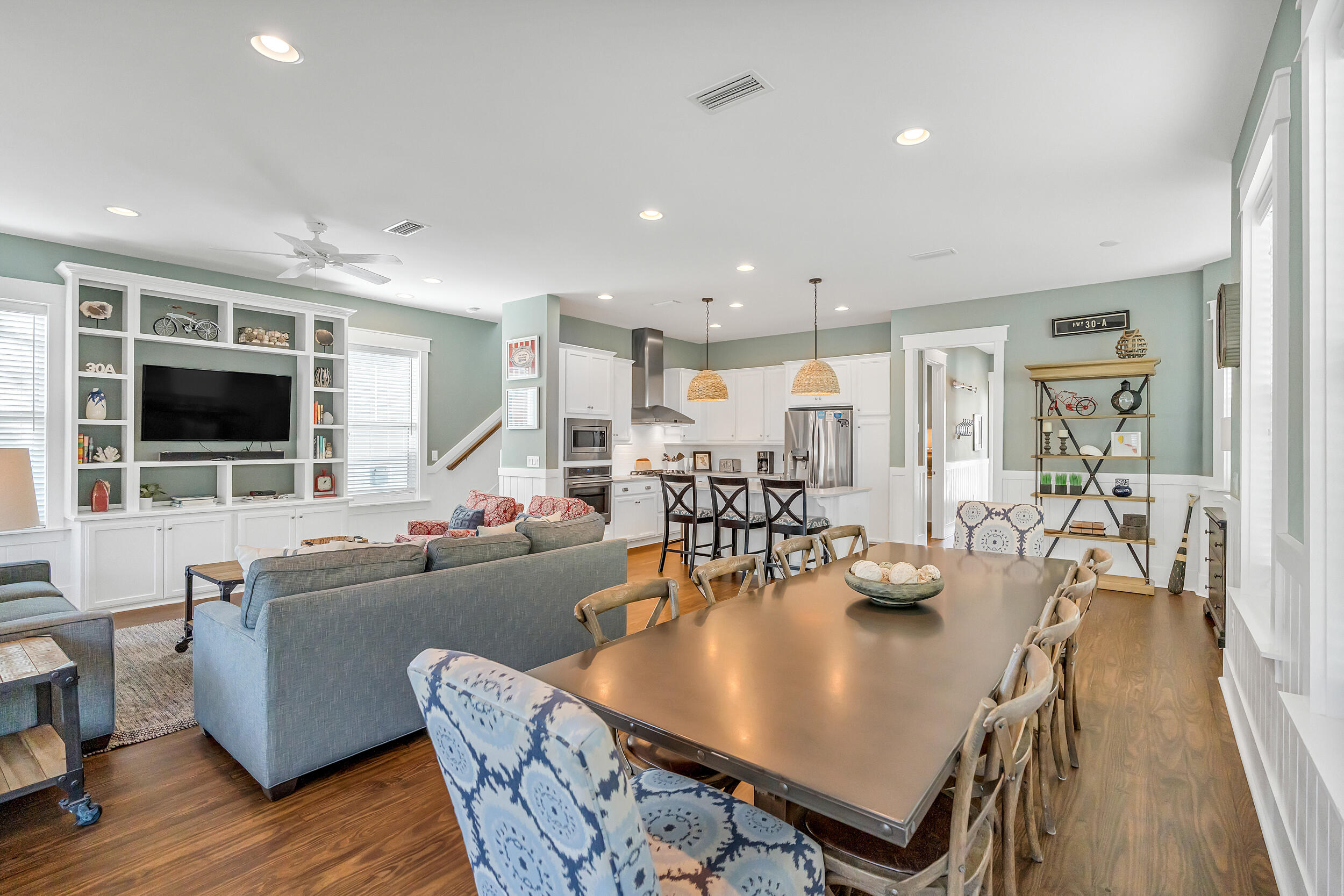654 Flatwoods Forest Loop Santa Rosa Beach, FL 32459 - Photo 6 of 53 a dining room with furniture wooden floor and a flat screen tv