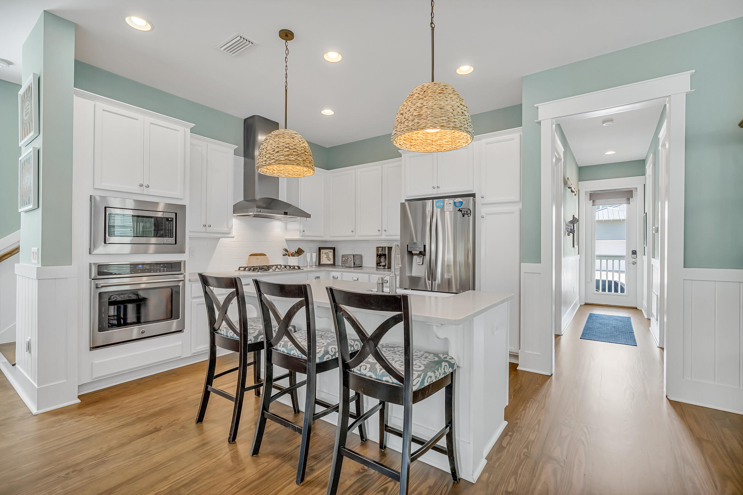 654 Flatwoods Forest Loop Santa Rosa Beach, FL 32459 - Photo 9 of 53 a kitchen with stainless steel appliances granite countertop a stove a refrigerator a oven a sink with a dining table and chairs