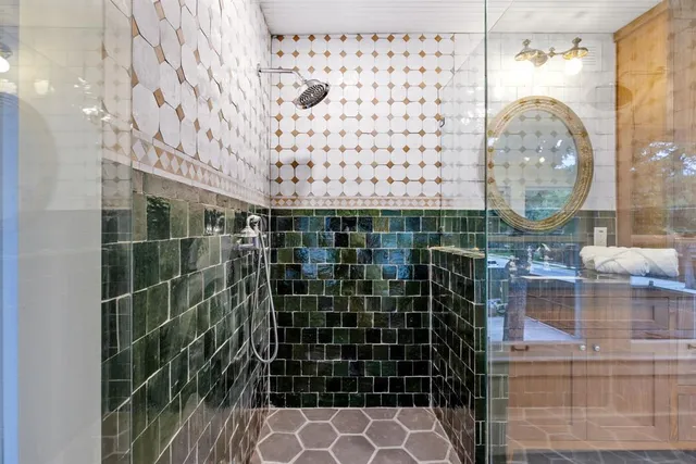 a bathroom with a glass shower door and a shower