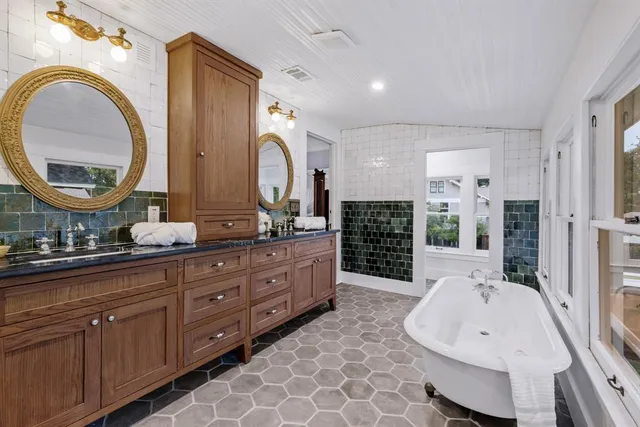 a spacious bathroom with a double vanity sink and a mirror