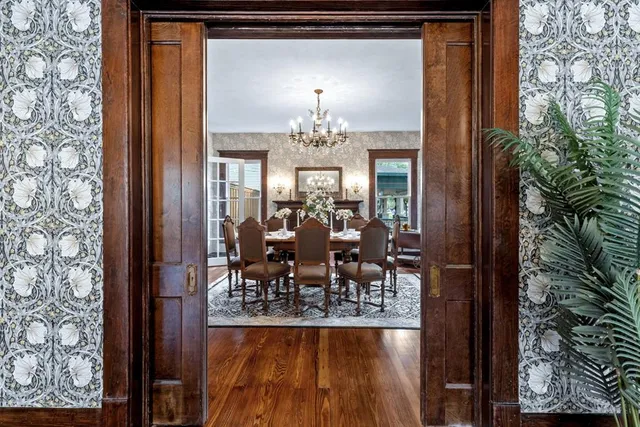 a living room with furniture a chandelier and a window