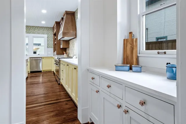 a living room with a table chairs and a refrigerator