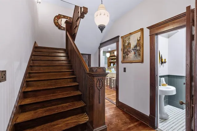 a bathroom with a double vanity sink a toilet and a mirror