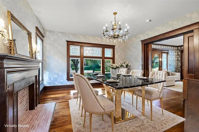 a view of a dining room with furniture a chandelier and wooden floor