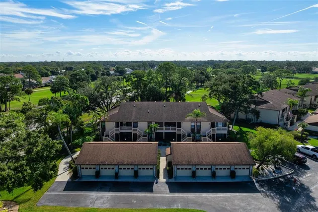 an aerial view of a house with garden space and street view