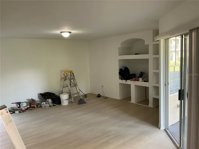 a view of a room with gym equipment and a window