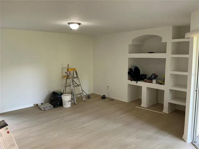 a view of a room with gym equipment and refrigerator