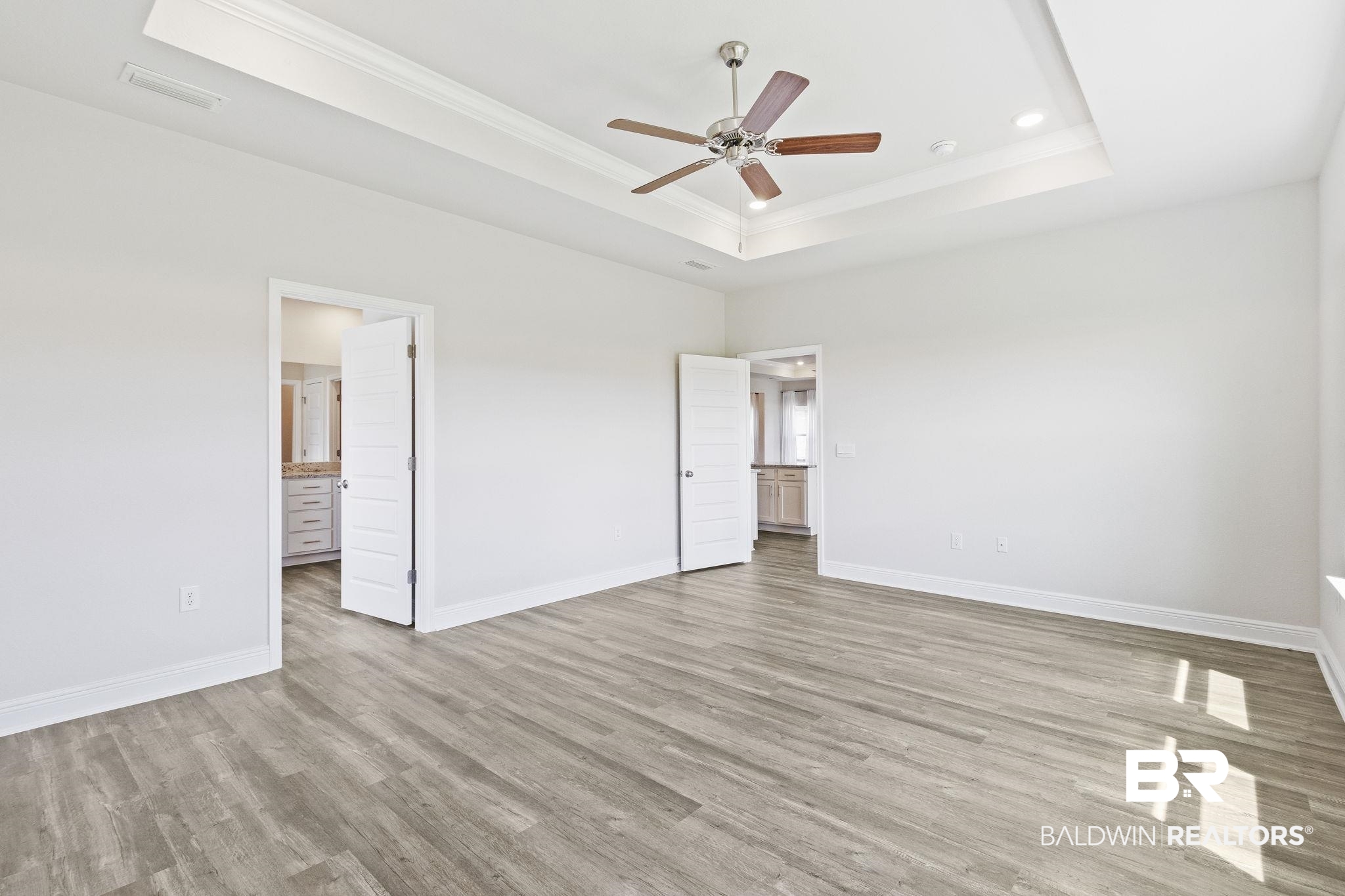 11303 Genuine Risk Circle Daphne, AL 36526 - Photo 38 of 100 Primary bedroom features a tray ceiling, ceiling fan, and connected bathroom