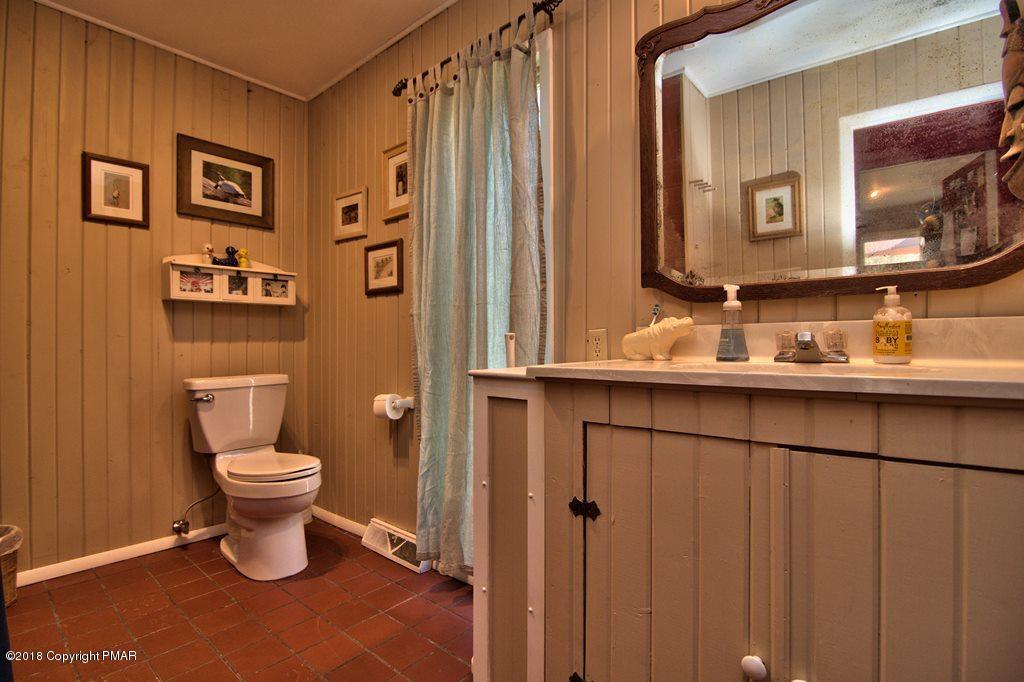 465 Pensyl Creek Road Stroudsburg, PA 18360 - Photo 16 of 80 a bathroom with a toilet a sink and a mirror