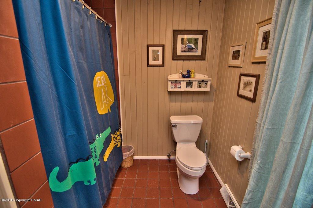 465 Pensyl Creek Road Stroudsburg, PA 18360 - Photo 17 of 80 a bathroom with a toilet and a mirror