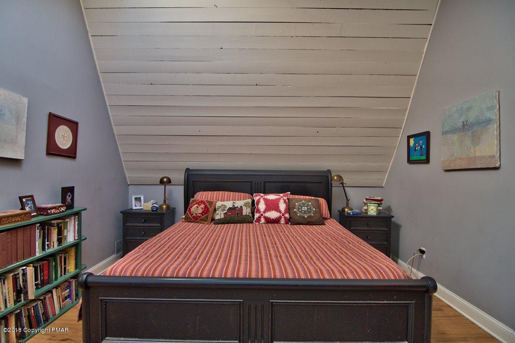 465 Pensyl Creek Road Stroudsburg, PA 18360 - Photo 21 of 80 a bedroom with a bed and a book shelf