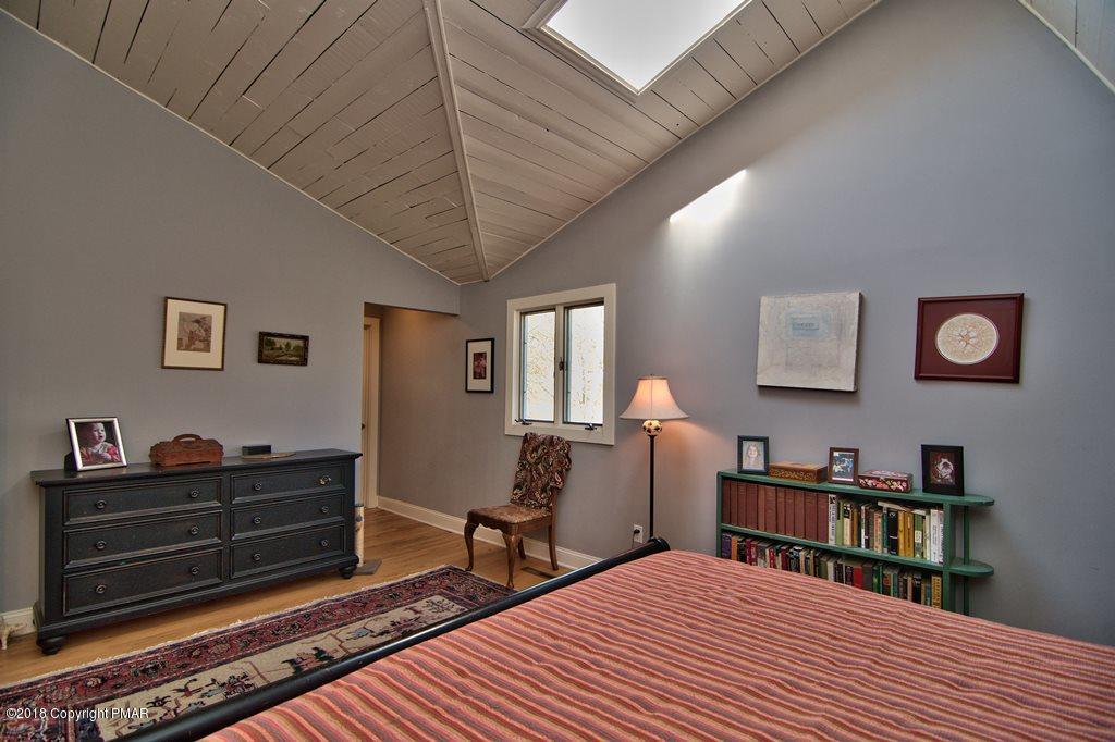 465 Pensyl Creek Road Stroudsburg, PA 18360 - Photo 22 of 80 a bed room with a bed and a book shelf