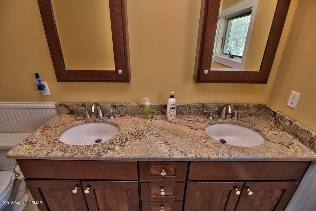 465 Pensyl Creek Road Stroudsburg, PA 18360 - Photo 26 of 80 a bathroom with a granite countertop sink and a mirror