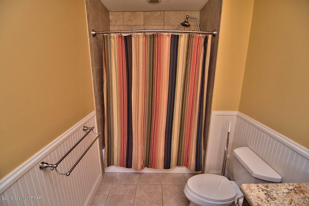 465 Pensyl Creek Road Stroudsburg, PA 18360 - Photo 27 of 80 a bathroom with a shower curtain and sink