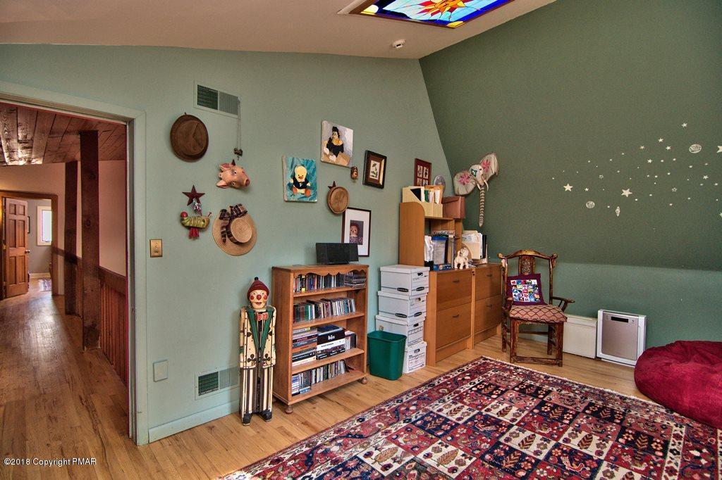 465 Pensyl Creek Road Stroudsburg, PA 18360 - Photo 29 of 80 a bedroom with a bed and wooden floor
