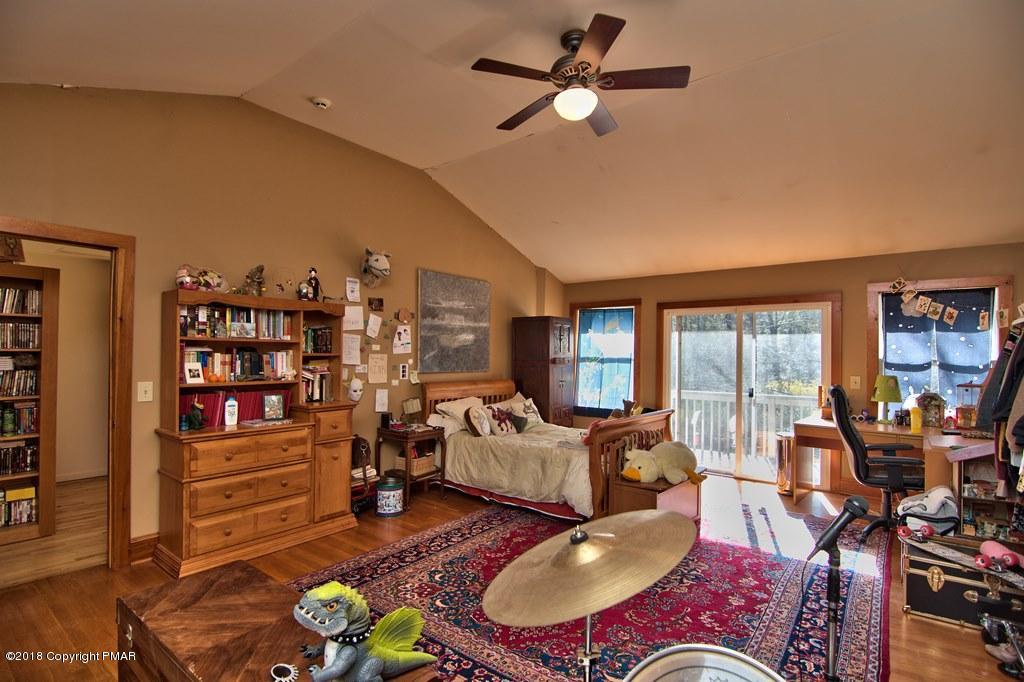 465 Pensyl Creek Road Stroudsburg, PA 18360 - Photo 32 of 80 a living room with furniture a rug and a large window